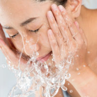 Young,Woman,Washing,Face,In,Room.