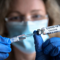 Covid-19,Vaccine,In,Researcher,Hands,,Female,Doctor,Holds,Syringe,And